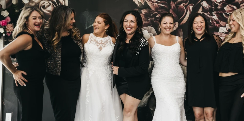 Models wearing a white and black dresses. Mobile image