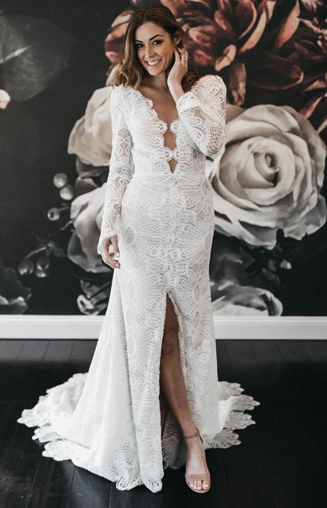 Model wearing a white gown by La Perle