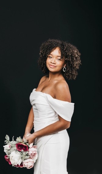 Model wearing a white gown by Love Label